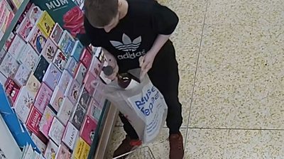 Joshua Turner stealing alcohol from a supermarket.