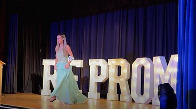 Girl in prom dress on stage