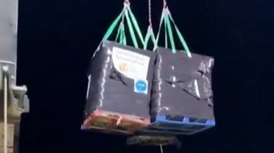 Crates of aid winched ashore in Gaza