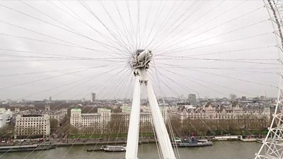 A member of the access specialist team and BBC reporter abseil down the London Eye