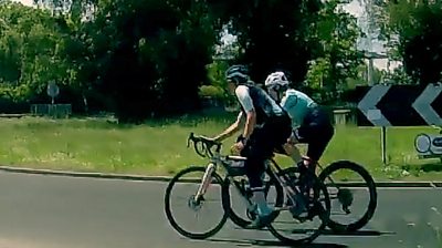 Two cyclists on a roundabout filmed by dashcam