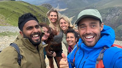 Eshaan, Amanda, Christine, Michaela, Sonali and Spencer do a windy selfie on a mountain