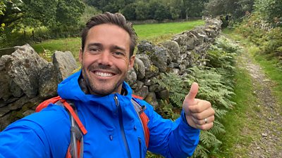 Spencer Matthews smiles to camera while doing a thumbs up in a selfie taken during filming for Pilgrimage: The Road Through North Wales. 
