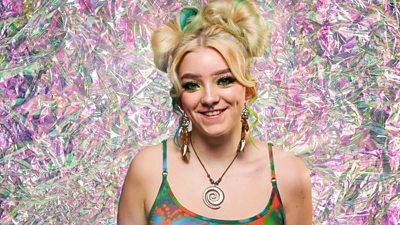 Contestant Ella with a green and pink diamond effect background