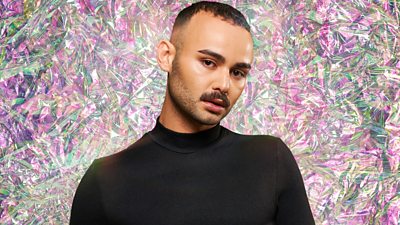 Contestant George with a green and pink diamond effect background