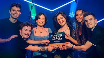 Image of Bottle Rockets holding a card that says Scottish Act of the Year
