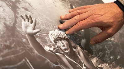 A man touches a 3D printed photograph
