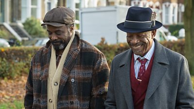 Ariyon Bakare and Lennie James as Morris and Barrington, walking side-by-side outdoors