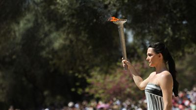 A Greek actress lights the flame in ancient Olympia, Greece