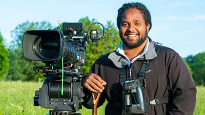 Hamza Yassin outside with a video camera