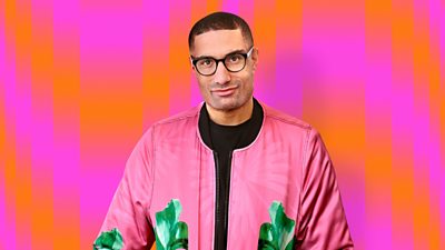 richie anderson wearing a black top with pink and green jacket with an orange and pink background