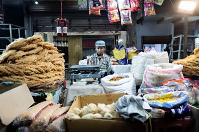 A Muslim boy in a sweet shop