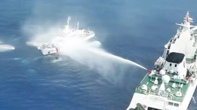 Water cannon firing at ship