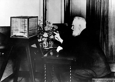 George Bernard Shaw sat at a desk