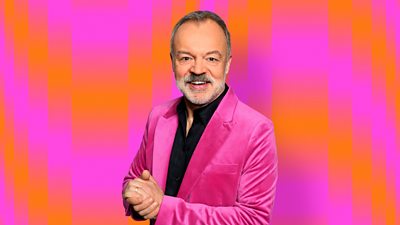 Graham Norton wears a bright pink velvet jacket
