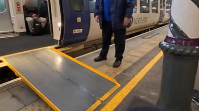 A bollard in front of a ramp leading up to a train