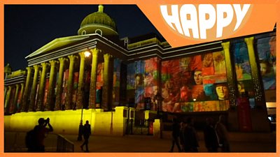 The National Gallery lit up and the Happy News logo