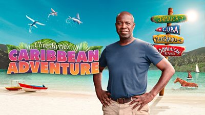 composite image with clive myrie with his hands on his hips. clive myrie's caribbean adventue in bold colourful text to the left. background of ocean and sand with little boars and horses in it with flying fish in the air