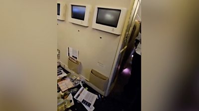 Objects strewn on floor of SQ321 cabin