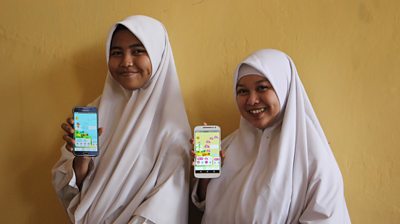 Young girls in Indonesia using the Oky app 