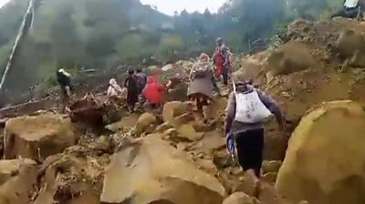 People scramble over rubble after landslide