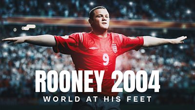 Image of wayne rooney in 2004 wearing red England shirt with his arms outstretched and blurred crowd in the background