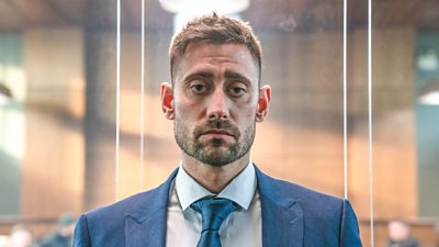 Michael Socha stares to camera with a sad expression. 