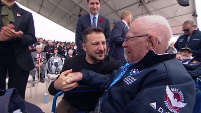 President Zelensky kneels to speak to a veteran in a wheelchair