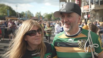 Northampton Saints fans - a man and a woman - outside their stadium.