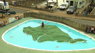Reporter standing on map of Isle of Wight