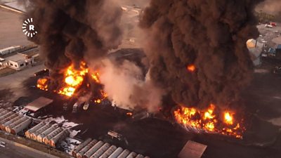 Drone footage showing a warehouse building on fire in northern Iraq