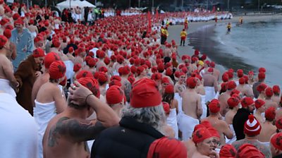 Swimmers participate in the annual nude winter solstice swim during Hobart's Dark Mofo festival