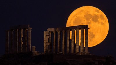 Strawberry Moon behind Temple of Poseidon, southern Greece