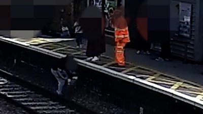 Child being rescued from train tracks