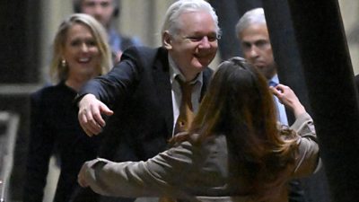 Julian Assange hugs his wife