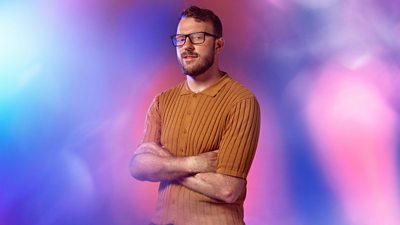 Composite image of JJ Chalmers with his arms crossed and looking to the camera. He's wearing a mustard colour jumper with buttons. Background of blurred pastel pinks and purples