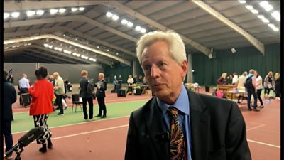 Richard Graham speaking in a large hall