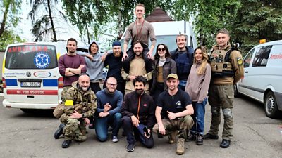 group of people posing for a photo and smiling