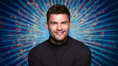 Headshot of Aljaž Škorjanec in front of Strictly Come Dancing branding.