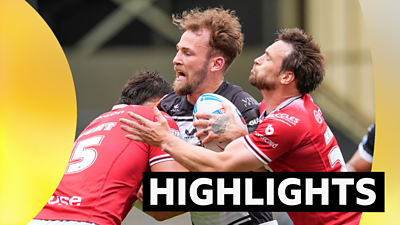 Ben Reynolds of Hull FC is tackled by Salford's Shane Wright and Joe Mellor