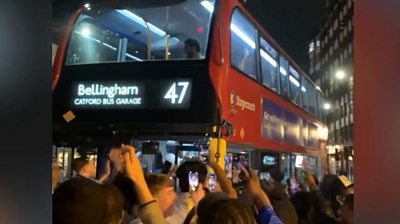 England fans surround the 'Bellingham bus' on Shoreditch High Street