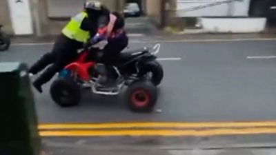 A police officer being struck by a quad bike