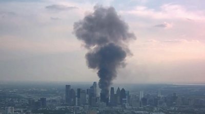 A plume of smoke rises above Dallas, Texas