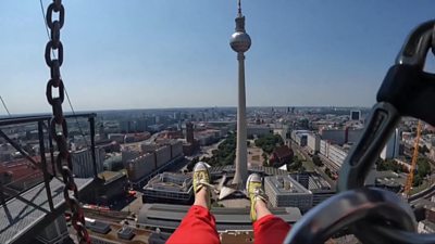 A point of view shot of a woman's legs hanging over Berlin