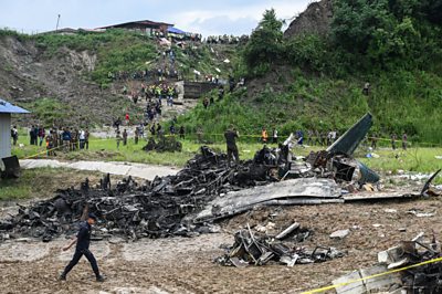 Officials examine a charred plane