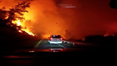 Car driving through wildfire