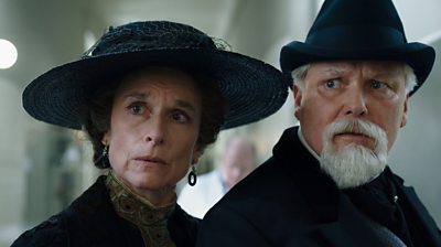 Close up of Amelia Bullmore (Rachel Liebermann) and Conleth Hill (Mendel Liebermann) looking concerned/shocked at something offscreen