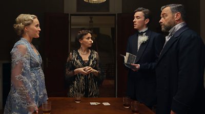 Characters Max Liebermann and Oskar Rheinhardt wearing formalwear and looking across the table to Clara Weiss. Leeah Liebermann is between them looking at the men