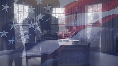 composite image of man sitting behind President's desk with people around him with a USA flag faded on top of the image