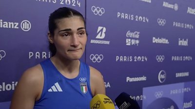 Angela Carini wearing Olympic kit and speaking into a BBC Sport microphone